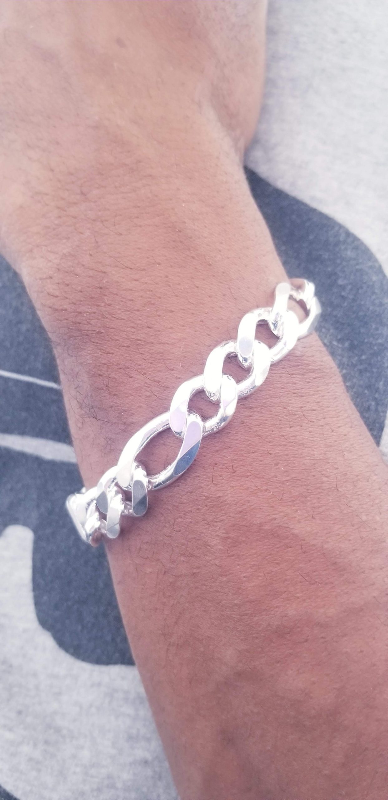 Bracelet Figaro 13mm 8.5 inches.jpg against chest